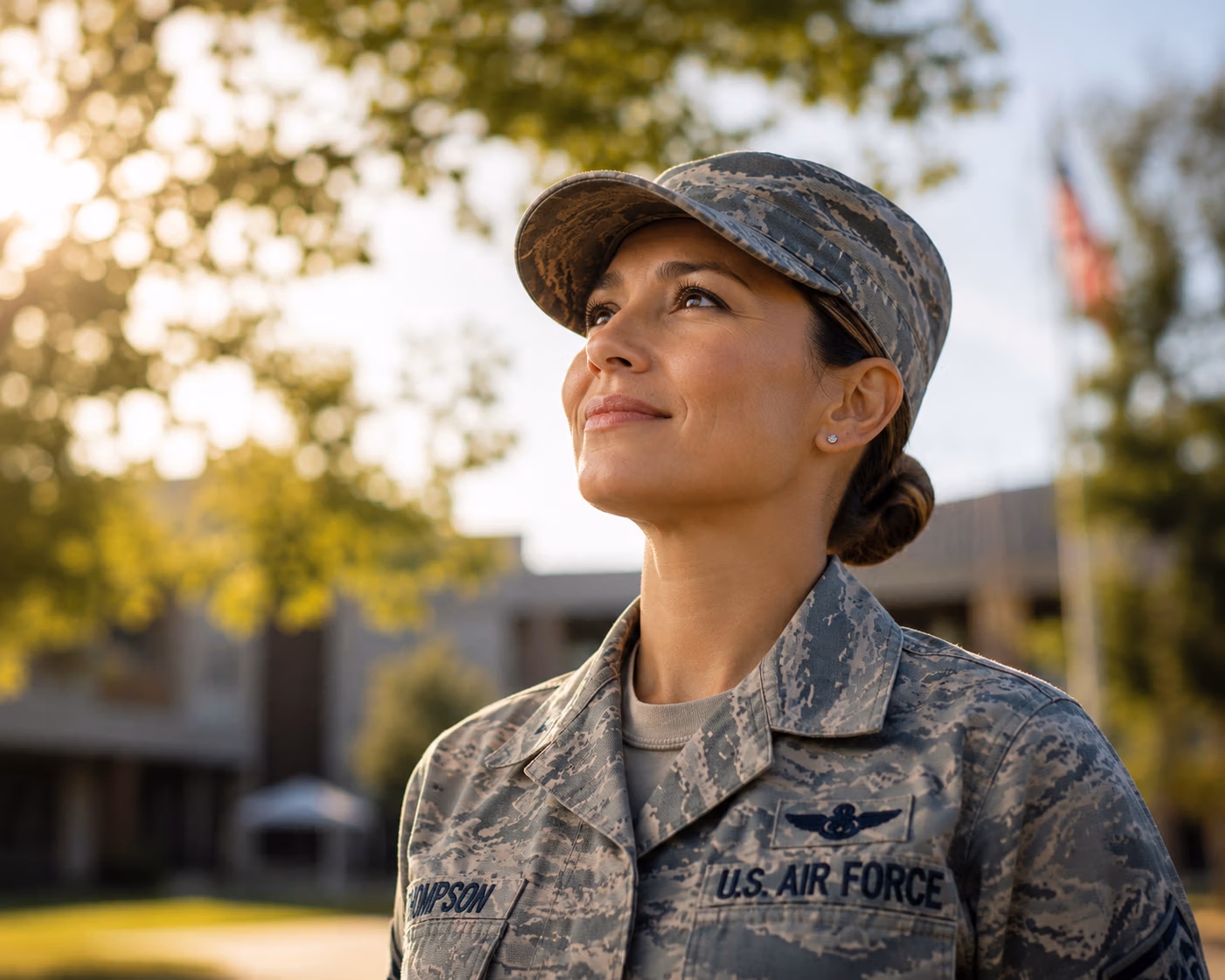 Confident Air Force woman in uniform standing outdoors in the sunlight, looking upward with calm confidence and renewed clarity.